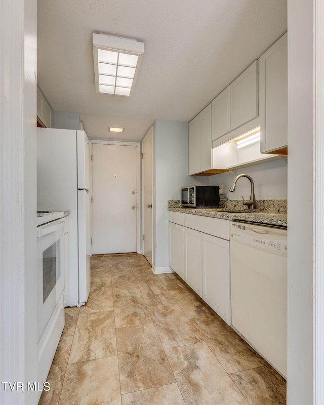 515 Pilgrim Ct Unit B, Johnson City, TN 37601 - kitchen with white appliances, white cabinets, and light stone counters