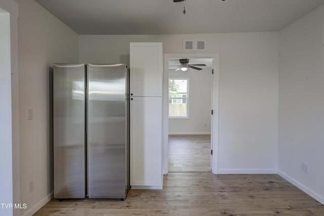 2116 Steadman St, Kingsport, TN 37664 - kitchen with freestanding refrigerator, ceiling fan, light wood finished floors, and white cabinets