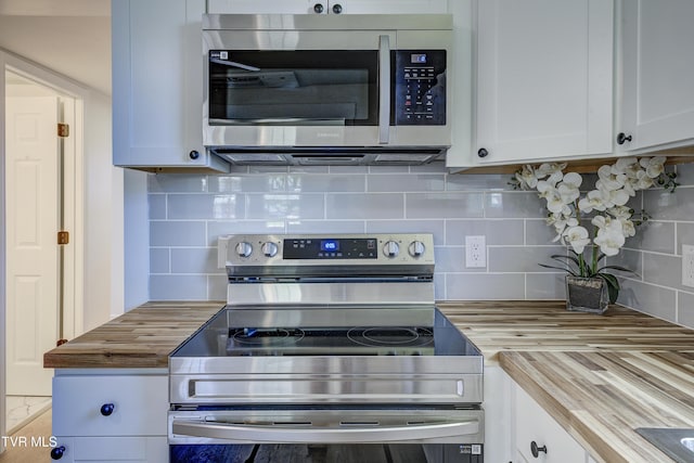 2116 Steadman St, Kingsport, TN 37664 - kitchen with stainless steel appliances, butcher block counters, white cabinets, and backsplash