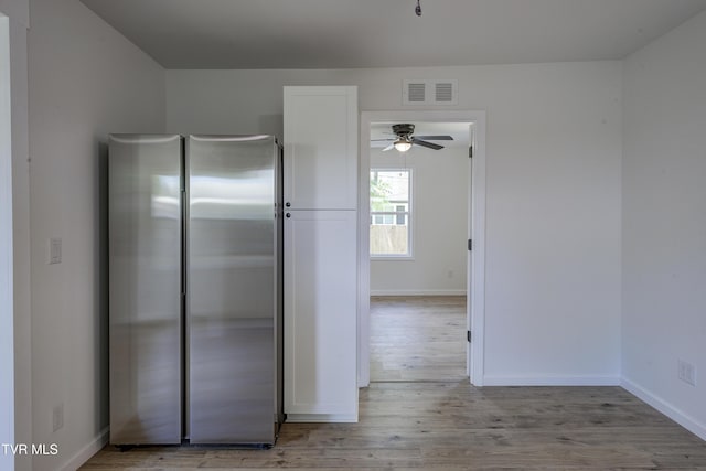 2116 Steadman St, Kingsport, TN 37664 - kitchen with freestanding refrigerator, wood finished floors, ceiling fan, baseboards, and white cabinets