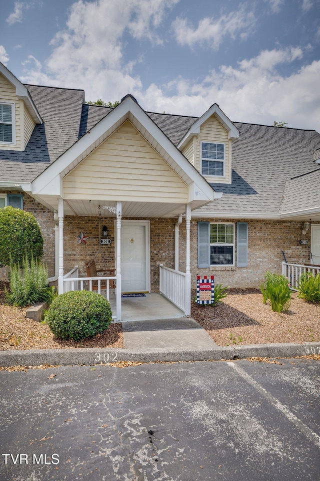302 Milton Ct Unit 302, Kingsport, TN 37664 - view of front of property featuring covered porch, brick siding, and roof with shingles