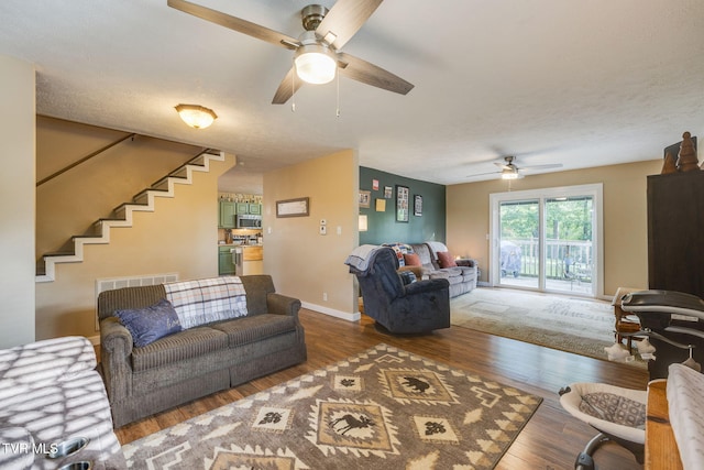 373 Mckeehan Ridge Rd, Elizabethton, TN 37643 - living room featuring a ceiling fan, wood finished floors, stairs, and baseboards