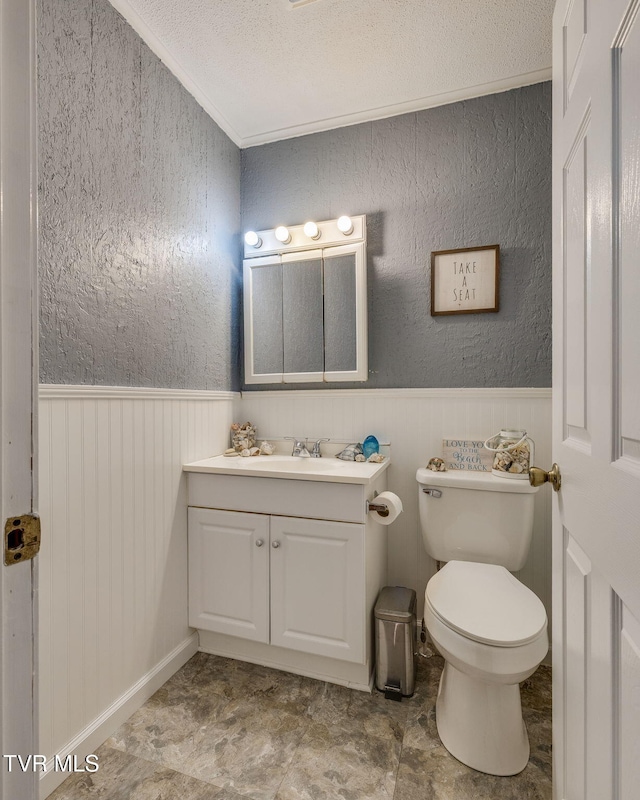 373 Mckeehan Ridge Rd, Elizabethton, TN 37643 - half bath with vanity, toilet, a wainscoted wall, a textured ceiling, and a textured wall