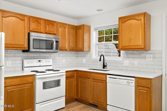 212 Amanda Ln Unit 2, Bristol, TN 37620 - kitchen featuring white appliances, a sink, light countertops, and brown cabinets