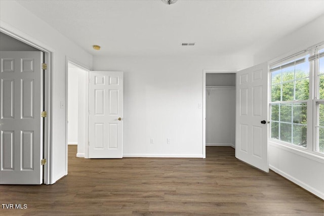 212 Amanda Ln Unit 2, Bristol, TN 37620 - unfurnished bedroom with multiple windows, wood finished floors, baseboards, and a closet