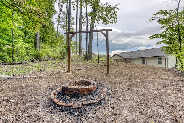 view of yard with a fire pit