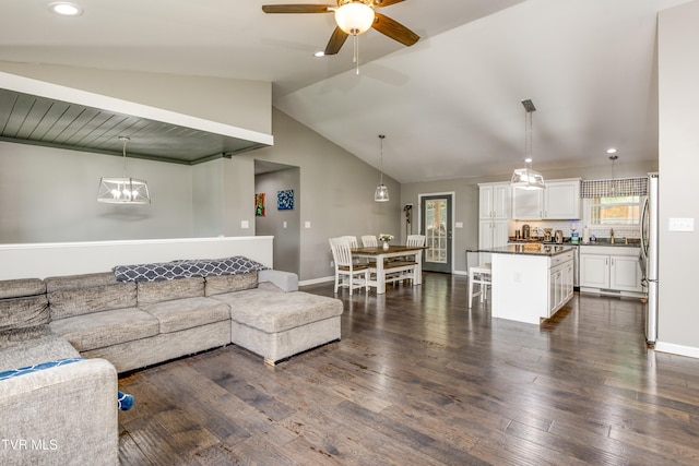 living room with lofted ceiling, dark wood finished floors, a ceiling fan, baseboards, and recessed lighting
