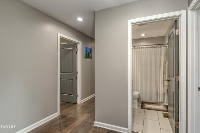 corridor with baseboards, recessed lighting, and dark wood-style flooring