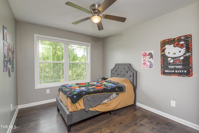 bedroom with baseboards, dark wood-type flooring, and a ceiling fan