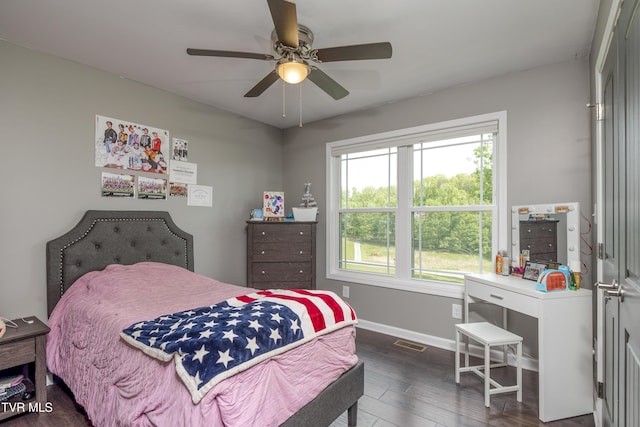 bedroom with baseboards, dark wood finished floors, and a ceiling fan