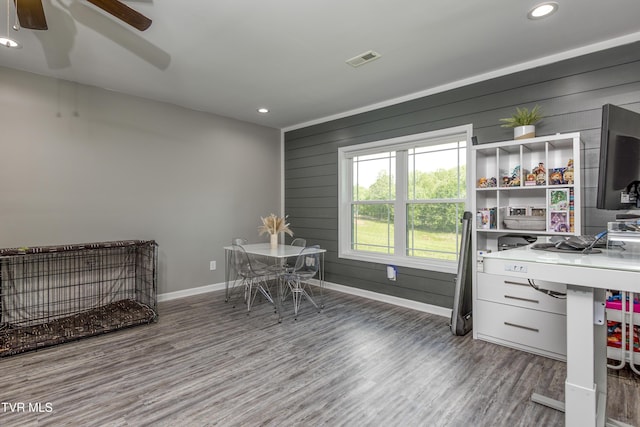home office with baseboards, wood finished floors, ceiling fan, recessed lighting, and wood walls
