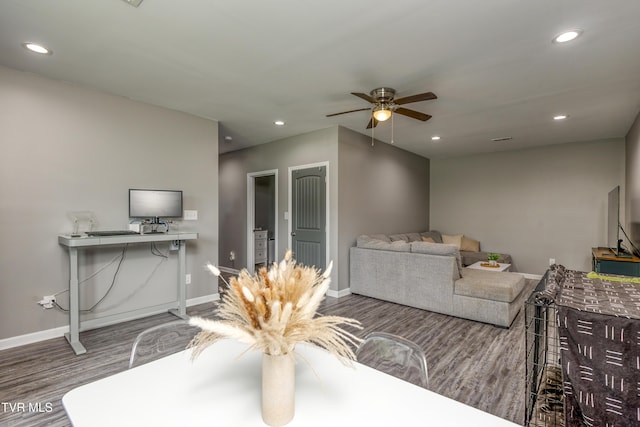 living area with a ceiling fan, baseboards, wood finished floors, recessed lighting, and a desk
