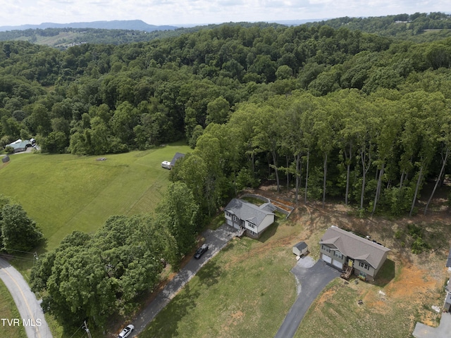aerial view of property and surrounding area with a forest