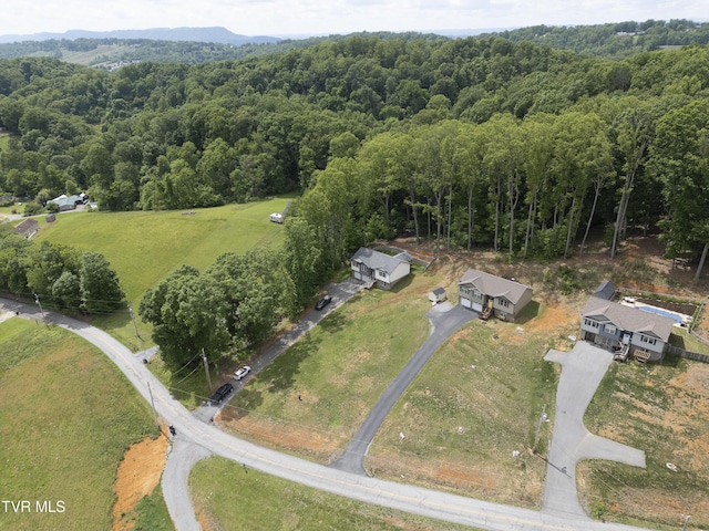view of property location featuring a forest