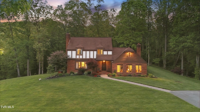 150 NW New Melrose St, Coeburn, VA 24230 - tudor home featuring a chimney, a yard, and brick siding