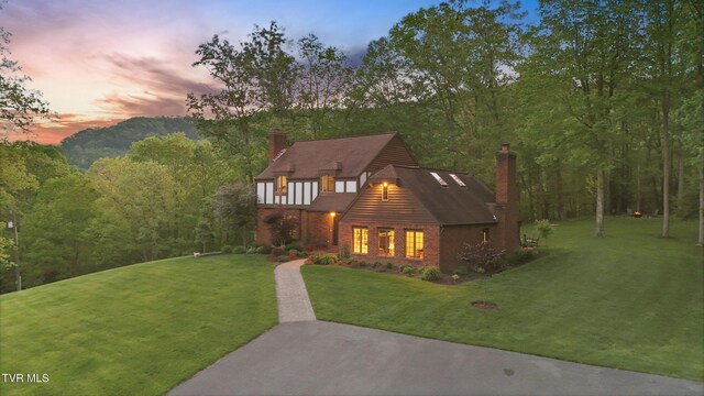 150 NW New Melrose St, Coeburn, VA 24230 - view of front of home with a chimney, a yard, a wooded view, and brick siding