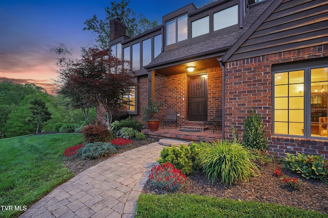 150 NW New Melrose St, Coeburn, VA 24230 - view of exterior entry with brick siding, a chimney, and a lawn