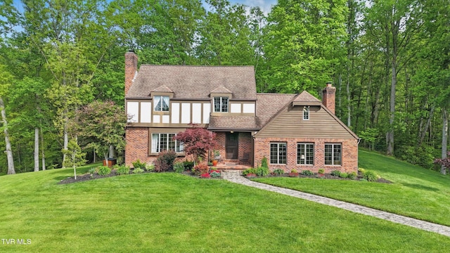 150 NW New Melrose St, Coeburn, VA 24230 - tudor home featuring a chimney, brick siding, and a front yard