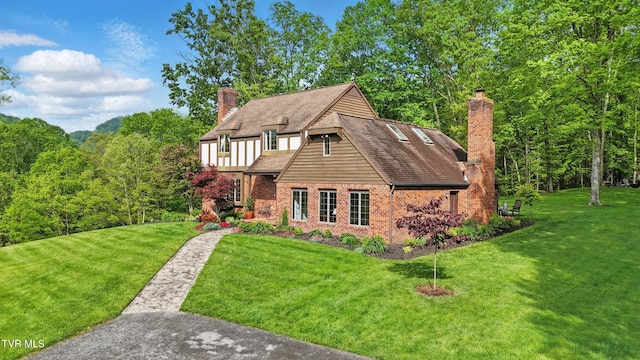 150 NW New Melrose St, Coeburn, VA 24230 - tudor house with a chimney, a front lawn, and brick siding