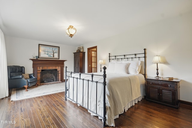 150 NW New Melrose St, Coeburn, VA 24230 - bedroom featuring hardwood / wood-style flooring, a fireplace, and baseboards