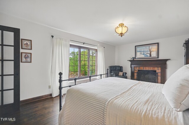150 NW New Melrose St, Coeburn, VA 24230 - bedroom featuring dark wood-type flooring, baseboards, and a fireplace
