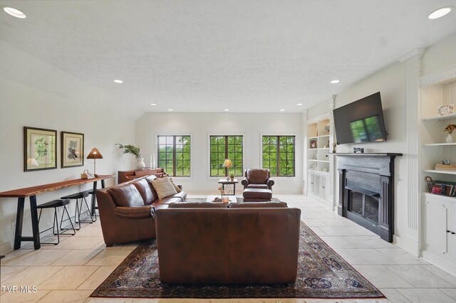 150 NW New Melrose St, Coeburn, VA 24230 - living area with built in shelves, a fireplace with flush hearth, recessed lighting, baseboards, and a textured ceiling