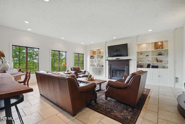 150 NW New Melrose St, Coeburn, VA 24230 - living room featuring recessed lighting, a glass covered fireplace, built in shelves, and a textured ceiling