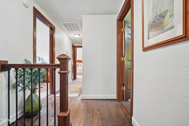 150 NW New Melrose St, Coeburn, VA 24230 - corridor featuring dark wood-type flooring, a textured wall, baseboards, and a textured ceiling