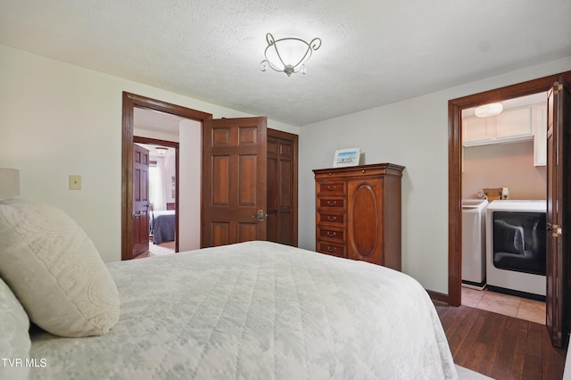 150 NW New Melrose St, Coeburn, VA 24230 - bedroom featuring washer and clothes dryer, wood-type flooring, and a closet