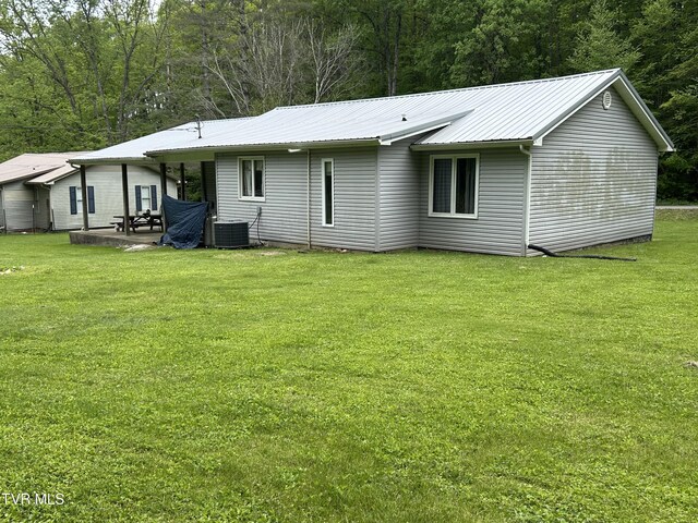 200 Glenbrook Mountain Rd, Keokee, VA 24265 - rear view of house featuring cooling unit, a lawn, a patio area, and metal roof