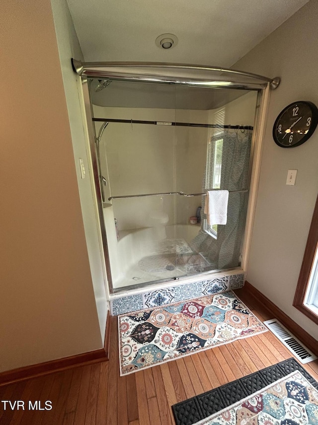 200 Glenbrook Mountain Rd, Keokee, VA 24265 - bathroom featuring a stall shower, wood finished floors, and baseboards