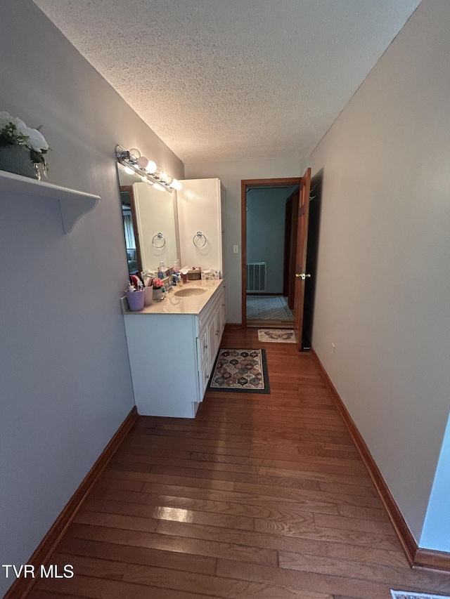 200 Glenbrook Mountain Rd, Keokee, VA 24265 - bathroom featuring hardwood / wood-style floors, a textured ceiling, vanity, and baseboards