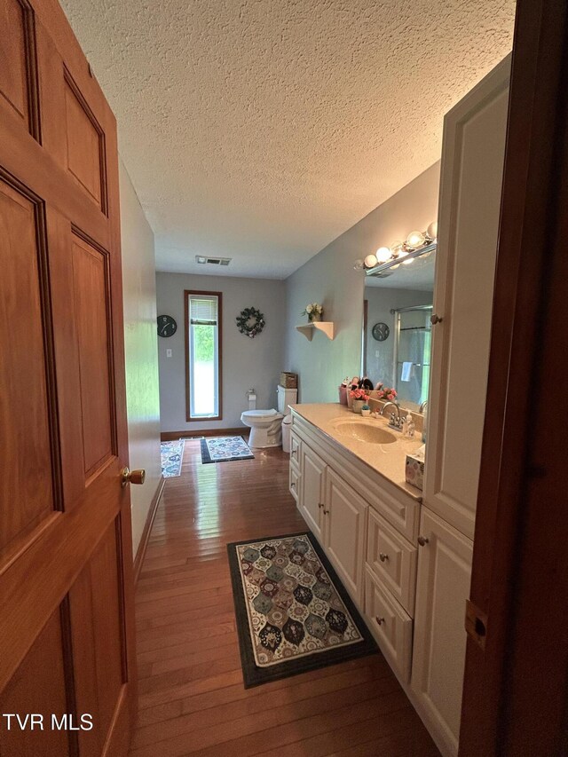 200 Glenbrook Mountain Rd, Keokee, VA 24265 - full bath featuring toilet, wood finished floors, a textured ceiling, vanity, and a shower