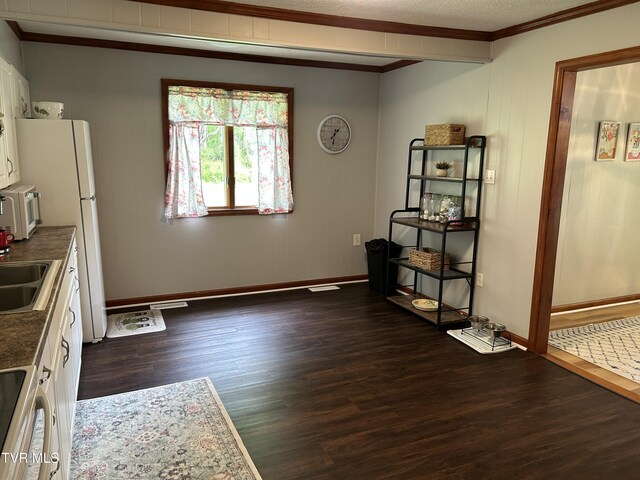 200 Glenbrook Mountain Rd, Keokee, VA 24265 - unfurnished dining area featuring crown molding, baseboards, and dark wood finished floors