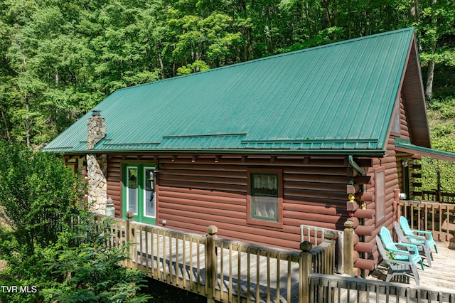 109 Hatley Hollow Rd, Butler, TN 37640 - view of side of property with log exterior, metal roof, a wooden deck, and a forest view