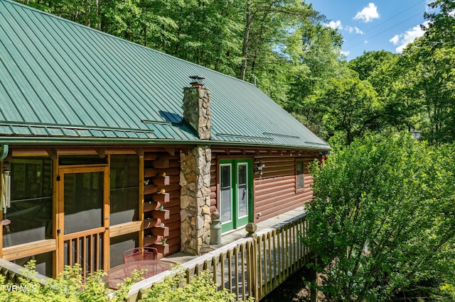 109 Hatley Hollow Rd, Butler, TN 37640 - view of side of home with log siding, a chimney, and metal roof