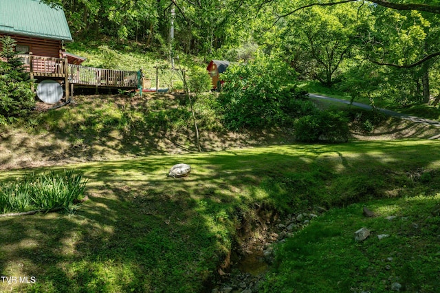 109 Hatley Hollow Rd, Butler, TN 37640 - view of grassy yard featuring a wooden deck and a wooded view