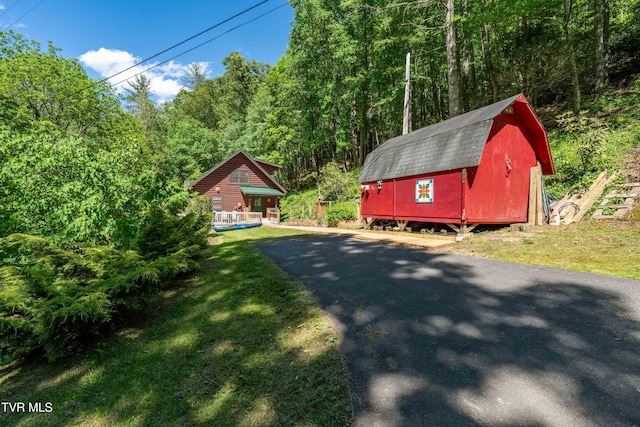 109 Hatley Hollow Rd, Butler, TN 37640 - view of property exterior with a gambrel roof, an outbuilding, a lawn, and a wooded view