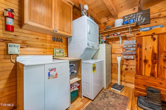 109 Hatley Hollow Rd, Butler, TN 37640 - washroom with cabinet space, stacked washer / dryer, wooden walls, light wood-type flooring, and wooden ceiling