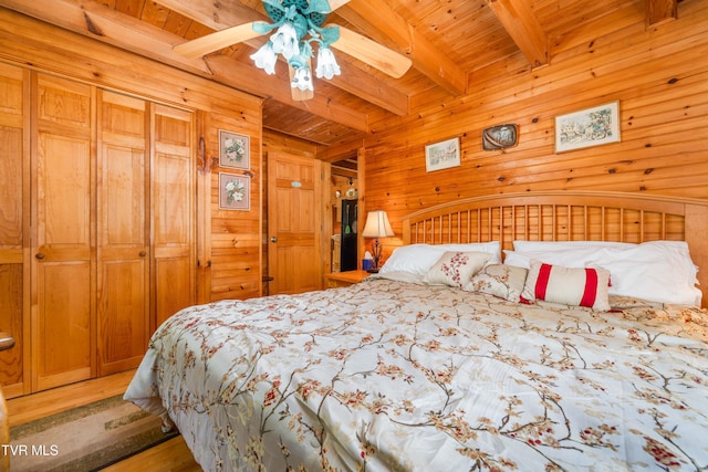 109 Hatley Hollow Rd, Butler, TN 37640 - bedroom with wooden walls, wood ceiling with exposed beams, light wood finished floors, and ceiling fan