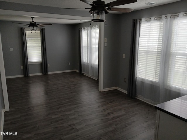 1318 Willow St, Kingsport, TN 37664 - empty room featuring ceiling fan, baseboards, and dark wood-style floors