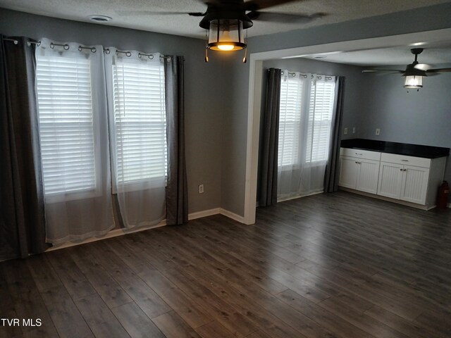 1318 Willow St, Kingsport, TN 37664 - empty room featuring ceiling fan, dark wood-type flooring, and baseboards