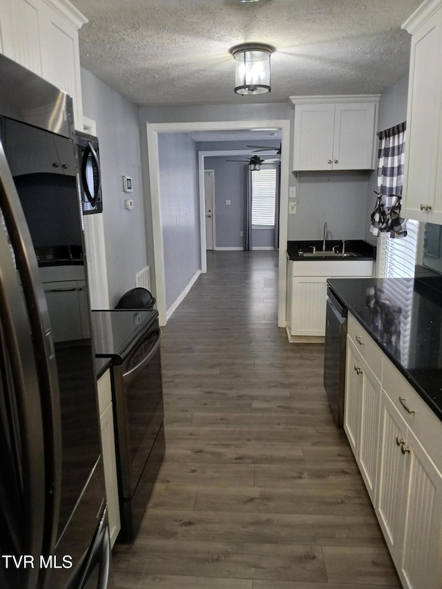 1318 Willow St, Kingsport, TN 37664 - kitchen featuring freestanding refrigerator, range, stainless steel dishwasher, dark countertops, and a textured ceiling