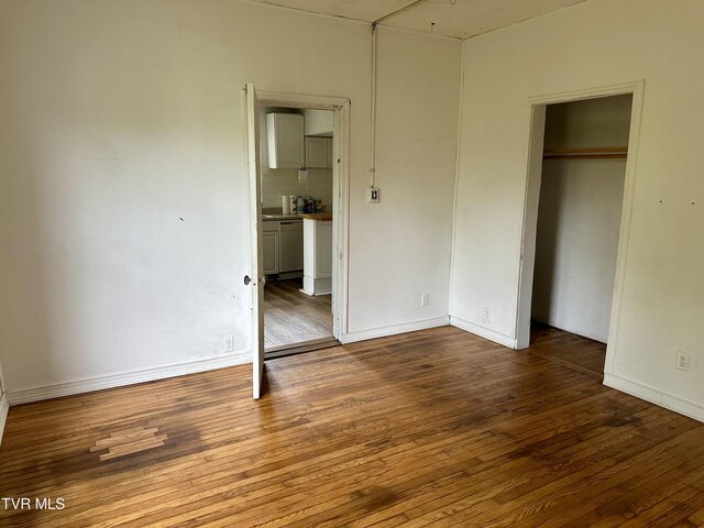 919 Russell St, Bristol, VA 24201 - unfurnished bedroom with wood finished floors, a closet, and baseboards