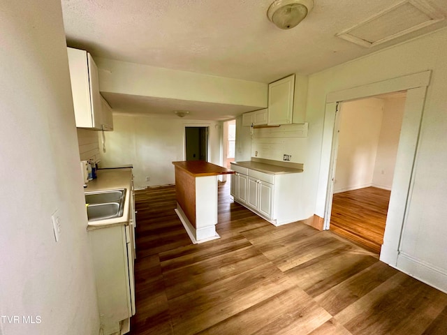 919 Russell St, Bristol, VA 24201 - kitchen featuring a sink, dark wood-style flooring, white cabinetry, baseboards, and a textured ceiling