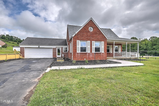 15497 Porterfield Hwy, Abingdon, VA 24210 - view of front facade featuring brick siding, driveway, a garage, covered porch, and roof with shingles
