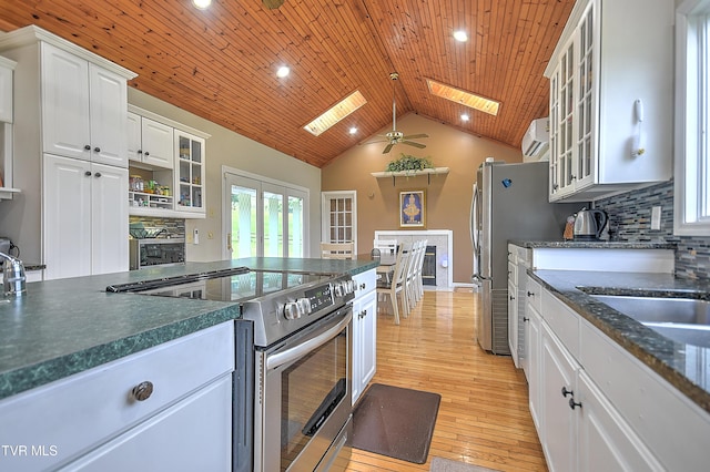 15497 Porterfield Hwy, Abingdon, VA 24210 - kitchen featuring appliances with stainless steel finishes, a skylight, white cabinetry, lofted ceiling, and ceiling fan