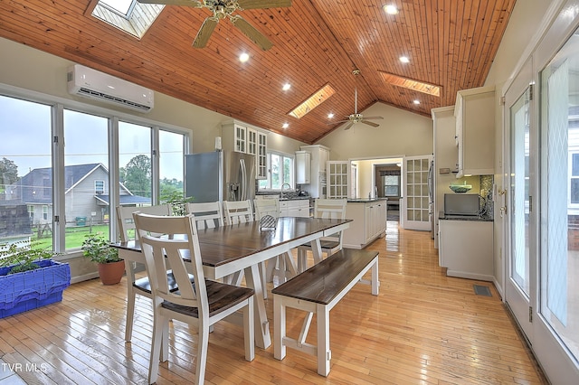 15497 Porterfield Hwy, Abingdon, VA 24210 - dining area with a wall unit AC, a skylight, a ceiling fan, light wood finished floors, and wooden ceiling