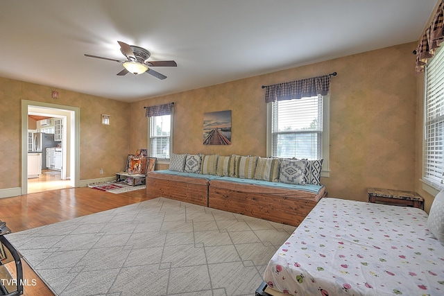 15497 Porterfield Hwy, Abingdon, VA 24210 - bedroom featuring wood finished floors, freestanding refrigerator, a ceiling fan, and baseboards
