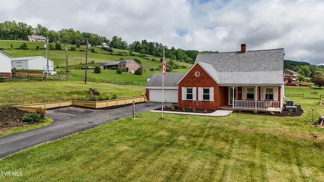 15497 Porterfield Hwy, Abingdon, VA 24210 - view of front of house featuring a porch, asphalt driveway, a shingled roof, a chimney, and brick siding